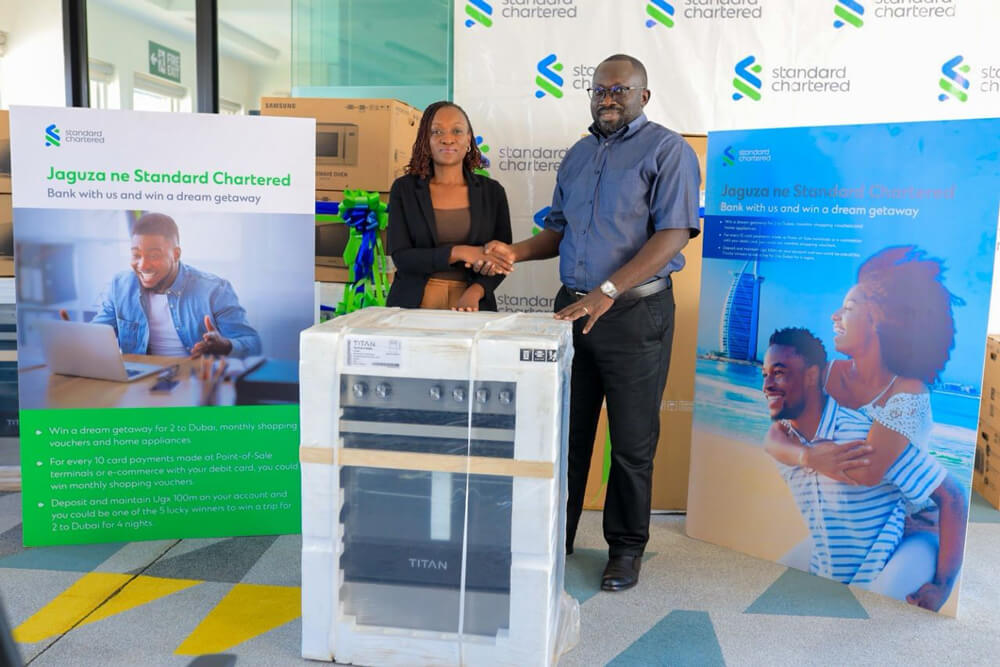 Margaret Kigozi the Head of Corporate Affairs, Brand and Marketing awards a client