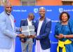 Stephen Segujja (R) Head, Economic Enterprise Restart Fund (EERF) and Cathering Poran, the CE Stanbic Business Incubator handing over a gift to the Rt. Hon. Joseph Muvawala the Prime Minister of Busog